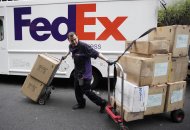 <p>               A FedEx driver carts packages in New York Thursday March 21, 2012. FedEx Corp. reports its third quarter earnings Thursday March 22, 2012   (AP Photo/Mark Lennihan)
