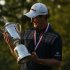 England's Justin Rose looks at the U.S. Open Trophy after winning the 2013 U.S. Open golf championship in Ardmore