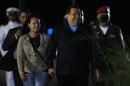 Venezuelan President Chavez walks with his daughter Rosa Virginia at the Maiquetia Airport in Caracas