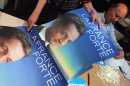 A man looks at campaign posters of France's incumbent president Nicolas Sarkozy Bordeaux
