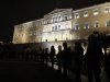 Riot police stand in front of the Greek Parliament during a protest in Athens, Thursday, Feb. 9, 2012. Greece's new austerity plan would make deep cuts to jobs and wages and it ignited fresh criticism from unions and the country's labor minister, who resigned in protest. (AP Photo/Thanassis Stavrakis)