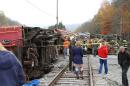 In this photo provided by the Pocahontas Times, crews work at the site where a truck carrying logs down Cheat Mountain on U.S. Route 250 crashed into the side of the train taking passengers on a scenic tour in rural Randolph County, W.Va., on Friday, Oct. 11, 2013. The crash killed one person and injured more than 60 others, according to emergency services officials. (AP Photo/The Pocahontas Times, Geoff Hamill)