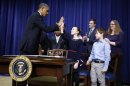 U.S. President Barack Obama (L) high fives children who wrote him letters about guns and gun control before sitting down to sign executive orders on a series of proposals to counter gun violence during an event at the White House in Washington