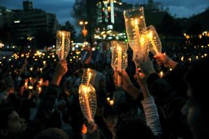 People hold candles to commemorate the 99th anniversary&nbsp;&hellip;