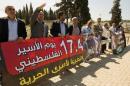 Arab Knesset Member's and community leaders carry placards as they protest outside the Megiddo Prison in northern Israel, demanding the release of administrative prisoners on March 28, 2013