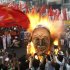 Protesters burn an effigy of Philippine President Benigno Aquino III during a rally near the Presidential Palace in Manila to celebrate international Labor Day known as May Day Tuesday May 1, 2012 in the Philippines. Thousands of workers marched under a brutal sun in Manila to demand a wage increase amid an onslaught of oil price increases, but the Philippine President rejected a $3 daily pay hike which the workers have been demanding since 1999 and warned may worsen inflation, spark layoffs and turn away foreign investors. (AP Photo/Bullit Marquez)