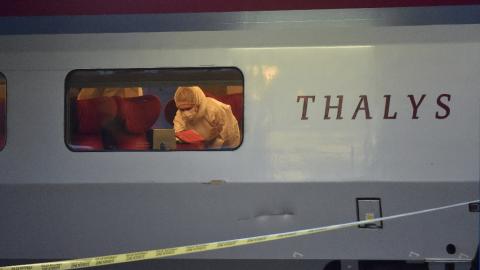 Police inspect the crime scene inside a Thalys train of French national railway operator SNCF at the main train station in Arras, France, on August 21, 2015