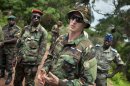 U.S. Army special forces Captain Gregory, 29, from Texas, center, who would only give his first name in accordance with special forces security guidelines, speaks with troops from the Central African Republic and Uganda, in Obo, Central African Republic, Sunday, April 29, 2012, where they are searching for infamous warlord Joseph Kony. Obo was the first place in the Central African Republic that Joseph Kony's Lord's Resistance Army (LRA) attacked in 2008 and today it's one of four forward operating locations where U.S. special forces have paired up with local troops and Ugandan soldiers to seek out Kony and hope he will stand trial at the International Criminal Court for war crimes and crimes against humanity after his forces cut a wide and bloody swath across several central African nations. (AP Photo/Ben Curtis)