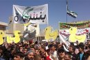 Demonstrators gather during a protest against Syria's President Assad in Binsh