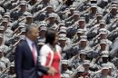 U.S. Army soldiers salute President Barack Obama and first lady Michelle Obama, as they arrive at the Fort Stewart Army post, Friday, April 27, 2012, in Fort Stewart, Ga. (AP Photo/David Goldman)