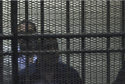 Egypt's former Interior Minister Habib el-Adly, front, stands behind bars during his trial on charges relating to the killing of nearly 900 protesters during the 18-day uprising that toppled Egypt's President Hosni Mubarak from power in February 2011, in Cairo, Egypt, Monday July 25, 2011. The court decided Monday to combine the trials of Habib el-Adly along with the ousted President Mubarak, and the hearing was broadcast live by state television, allowing millions of Egyptians to see el-Adly and his co-defendants in detention for the first time. (AP Photo)