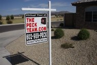 A real estate sales sign sits outside of a house for sale in Phoenix, Arizona June 2, 2009. REUTERS/Joshua Lott