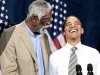 President Barack Obama, right, smiles as he is introduced by NBA basketball hall-of-famer, Bill Russell, left, during a Democratic fundraiser at the Paramount Theater, Sunday, Sept., 25, 2011, in Seattle. (AP Photo/Pablo Martinez Monsivais)