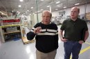 Transparent Container quality manager Walters and McManus talk on the company's manufacturing floor in Addison