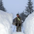 In this photo provided by the Alaska National Guard, a Guardsman clears a walkway of snow Monday, Jan. 9, 2012, in Cordova, Alaska. There are currently 57 National Guardsmen assisting citizens in this small Alaska town dig out from a series of winter storms. (AP Photo/Spc. Balinda O’Neal, Alaska National Guard)