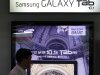 A man walks past in front of Samsung Electronics advertisement at its showroom in Seoul, South Korea, Friday, July 29, 2011. Samsung's net profit slid 18 percent in the second quarter as weakness in semiconductors and liquid crystal displays countered the electronics giant's growing strength in smartphones. (AP Photo/Lee Jin-man)