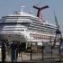 The cruise ship Carnival Triumph is moored at a dock in Mobile, Ala., Friday, Feb. 15, 2013. The ship, which docked Thursday in Mobile after drifting nearly powerless in the Gulf of Mexico for five days, was moved Friday from the cruise terminal to a repair facility. The ship carrying more than 4,200 passengers and crew members had been idled for nearly a week in the Gulf of Mexico following an engine room fire. (AP Photo/Dave Martin)
