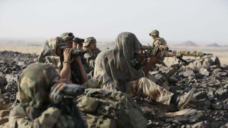 French soldier snipers wearing ghillie suits sit on the top of a hill during operations in the Ifoghas mountain range, northern Mali, on March 16, 2013