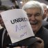 Republican presidential candidate, former House Speaker Newt Gingrich, displays an autographed sign during a campaign stop at Tommy’s Country Ham House, Saturday, Jan. 21, 2012, in Greenville, S.C., on South Carolina's Republican primary election day. (AP Photo/Matt Rourke)