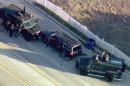 In this image taken from video, armored vehicles surround an SUV following a shootout in San Bernardino, Calif., Wednesday, Dec. 2, 2015. The scene followed a military-style attack that killed multiple people and wounded others at a California center that serves people with developmental disabilities, authorities said. (KTTV via AP)