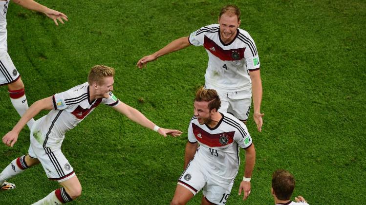 Germany&#39;s Mario Goetze, center, celebrates scoring his side&#39;s first goal during the World Cup final soccer match between Germany and Argentina at the Maracana Stadium in Rio de Janeiro, Brazil, Sunday, July 13, 2014