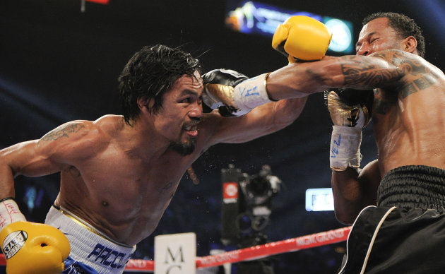Manny Pacquiao, left, throws a punch against Shane Mosley in the fourth round during a WBO welterweight title bout, Saturday, May 7, 2011, in Las Vegas.  (AP Photo/Mark Terrill)