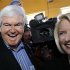 Republican presidential candidate, former House speaker Newt Gingrich, left, and wife, Callista, right, move through a crowded pub during a campaign stop, Sunday, Jan. 1, 2012, in Ames, Iowa. (AP Photo/Eric Gay)