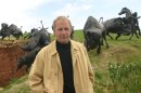 FILE - In this 2003 file photo provided by Touchstone Pictures via RPNewsFoto, actor Kevin Costner stands with bronze sculptures of bison and American Indians at his Tatanka attraction near Deadwood, S.D. The South Dakota Supreme Court on Monday, March 19, 2012, will hear an appeal of ruling that found Costner did not breach a contract with an artist whom he commissioned to produce the sculptures. The sculptures were commissioned for a resort he planned in South Dakota's Black Hills. That resort was never built but he instead placed the sculpture at his Tatanka attraction near Deadwood. (AP Photo/PRNewsFoto/Touchstone Pictures, File)