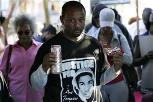 Community activist Ali holds Skittles and an ice tea 