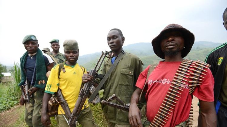 Members of the APCLS (Alliance of Patriots for a Free and Sovereign Congo) paramilitary group take part in a meeting in the village of Nyabiondo on July 26, 2013