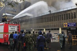 Fire fighters struggle to put out a fire at the Jomo …