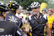 FILE - In this Aug. 22, 2010, file photo, cyclist Lance Armstrong greets fellow riders prior to the start of his Livestrong Challenge 10K ride for cancer in Blue Bell, Pa. Armstrong said Wednesday, Oct. 17, 2012, he is stepping down as chairman of his Livestrong cancer-fighting charity so the group can focus on its mission instead of its founder's problems. The move came a week after the U.S. Anti-Doping Agency released a massive report detailing allegations of widespread doping by Armstrong and his teams when he won the Tour de France seven consecutive times from 1999 to 2005. (AP Photo/Bradley C Bower, File)