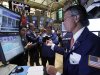 In this Aug. 2, 2011 photo, trader Donald Civitanova, right, dirtects trades at his post on the floor of the New York Stock Exchange. Stocks continued to be buffeted by concerns over the U.S. economy and Europe's debt problems but the Bank of Japan's latest intervention to stem the rise of the yen has helped limit the sell-off, especially in comparison to recent sessions.(AP Photo/Richard Drew)