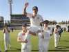 Australia's Ponting is carried off the WACA in Perth by tWarner and Clarke after the third test cricket match