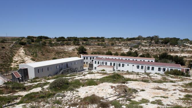 A view of the holding center of the Island of Lampedusa, southern Italy, Tuesday, May 12, 2015. The European Union is seeking a U.N. Security Council resolution within days to allow aggressive action to hunt down people-smugglers in the Mediterranean and destroy their boats, a senior EU official said Tuesday. (AP Photo/Antonio Calanni)