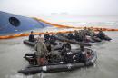 South Korean rescue team members prepare to search for passengers of a ferry sinking off South Korea's southern coast, in the water off the southern coast near Jindo, south of Seoul, South Korea, Thursday, April 17, 2014. Fears rose Thursday for the fate of more than 280 passengers still missing more than 24 hours after their ferry flipped onto its side and filled with water off the southern coast of South Korea. (AP Photo/Yonhap) KOREA OUT