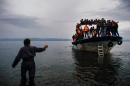 Migrants arrive by boat on the Greek island of Lesbos