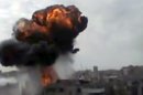 In this image made from amateur video released by the Shaam News Network and accessed Sunday, April 15, 2012, smoke billows an impact following purported shelling in Homs, Syria. Syrian troops are reported to have shelled residential neighborhoods dominated by rebels in the central city of Homs Sunday, activists said, killing at least three people hours before the first batch of United Nations observers were to arrive in Damascus to shore up a shaky truce. (AP Photo/Shaam News Network via AP video) TV OUT, THE ASSOCIATED PRESS CANNOT INDEPENDENTLY VERIFY THE CONTENT, DATE, LOCATION OR AUTHENTICITY OF THIS MATERIAL