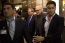 U.N.-Arab League envoy Lakhdar Brahimi, center right, and Deputy Syrian Foreign Minister Faisal Mekdad arrive to a hotel surrounded by security Monday, Oct. 28, 2013 in Damascus, Syria. Brahimi is on his first trip to the country in almost a year. (AP Photo/Dusan Vranic)