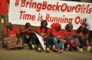 Members of Abuja "Bring Back Our Girls" protest group sit during a protest march, organized by the group to the Presidential Villa, in Abuja