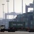 In this photo taken Tuesday, Feb. 28, 2012, a truck transports a container to be loaded onto a ship at a port in Tianjin, China. China says its trade rebounded in February after a Lunar New Year slowdown but a broader measure gave clear signs both global and Chinese demand are weakening. Customs data Saturday, March 10, 2012 showed exports grew 18.4 percent over a year earlier, up from January's 0.5 percent contraction. Imports jumped 39.6 percent, up from the previous month's decline of 15 percent. (AP Photo/Alexander F. Yuan)