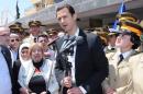 President Bashar al-Assad addresses his supporters at a school in an undisclosed location during an event to commemorate Syria's Martyrs' Day