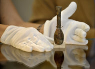 A scientist at the university of Bonn displays a flask in Bonn, Germany, Friday, Aug. 19, 2011. The university says researchers have discovered a carcinogenic substance in the flask believed to have belonged to Queen Hatshepsut, who ruled Egypt 3,500 years ago. The scientists spent two years researching the dried-out contents of the flask, which is part of its Egyptian Museum's collection and bears an inscription saying it belonged to Hatshepshut. (AP Photo/dapd, Sascha Schuermann)