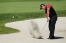 U.S. golfer Woods hits from a fairway trap on the 10th hole during final round play at the Farmers Insurance Open in San Diego