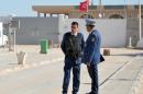 Tunisia police stand guard in front of the country's closed border with Libya on November 26, 2015 in Ras Jdir