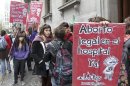 Pro-abortion activists hold placards outside the Buenos Aires' Legislative Palace
