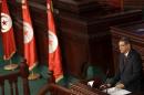 Tunisian PM Essid delivers a speech after attack Tuesday that killed at least 13 people and forced the government to impose a state of national emergency in Tunis