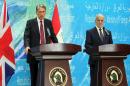 Iraqi Foreign Minister Ibrahim al-Jaafari listens as British Foreign Secretary Philip Hammond talks during a joint press conference in Baghdad on October 13, 2014