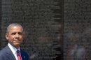 US President Barack Obama stands at the Vietnam Veterans Memorial Wall