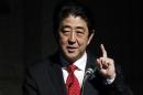 Japan's PM Abe gestures as he gives a keynote address at Japan Summit 2014 hosted by the Economist magazine in Tokyo